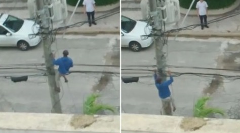 Homem arrisca a vida ao escalar poste para tentar roubar fiação e é detido por populares em Guarujá